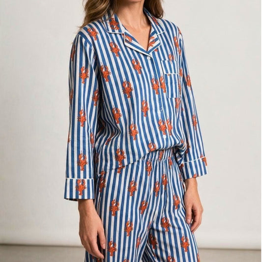 Blue and white striped cotton pyjama set featuring a red lobster print and white piping, shown with a matching fabric travel pouch.