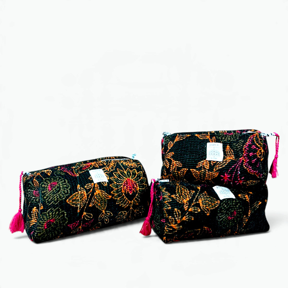 Set of three black velvet quilted wash bags with orange and magenta floral design and pink tassel zip pulls