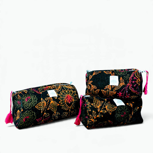 Set of three black velvet quilted wash bags with orange and magenta floral design and pink tassel zip pulls
