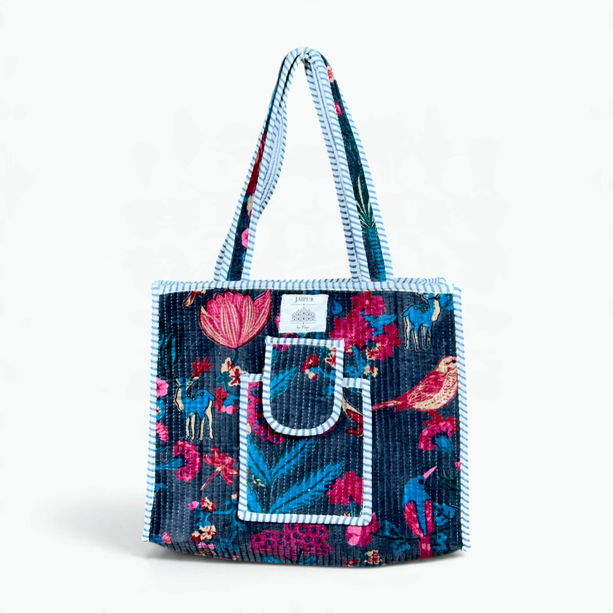 Midnight blue quilted velvet tote bag with pink and turquoise birds, deer and lotus flower print, front pocket and light blue striped piping and handles