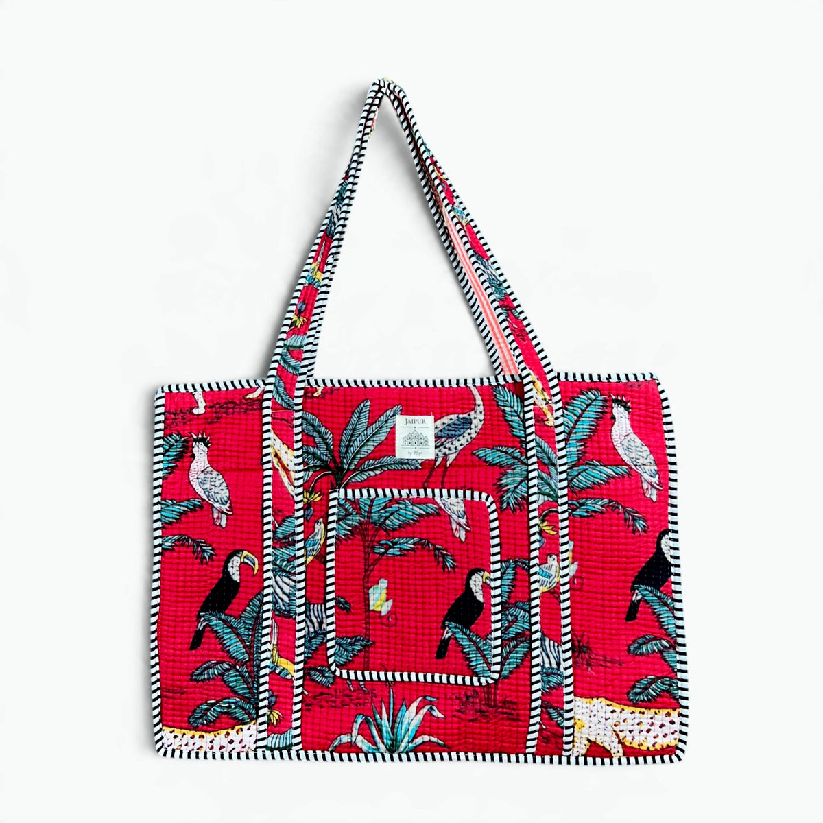 Red quilted cotton tote bag with hand block printed toucan and jungle print and black and white striped piping