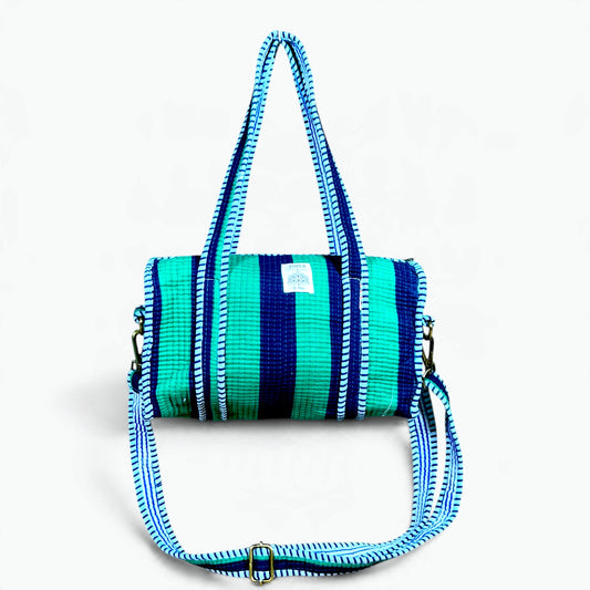 Green and navy striped quilted cotton mini duffle bag with blue and white striped handles and shoulder strap
