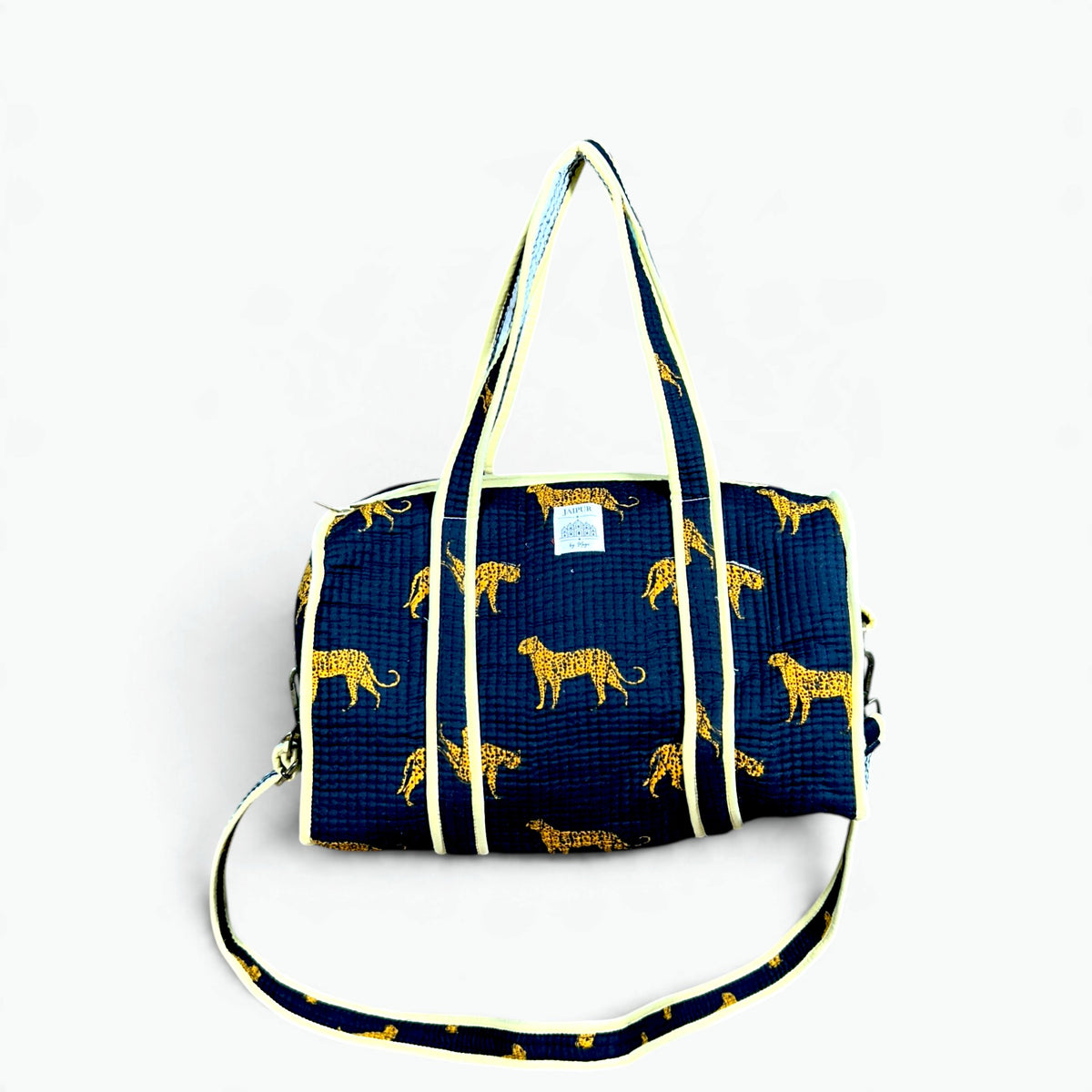 Navy quilted cotton mini duffle bag with golden leopard print, butter yellow piping, carry handles and shoulder strap