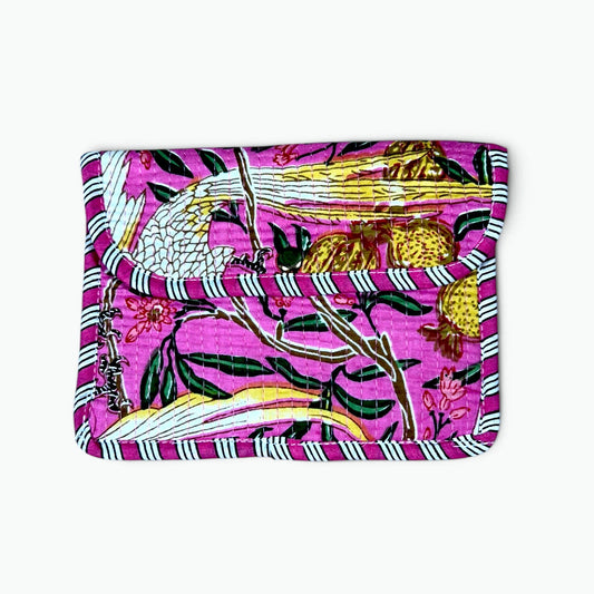 A small zippered pouch or wallet featuring a vibrant magenta pink background with a detailed botanical and bird pattern in green, yellow, white, and black, finished with a striped border.