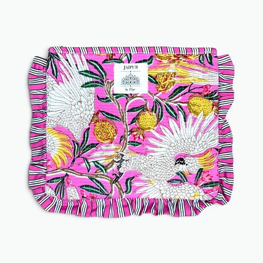 Bright pink quilted cotton pouch featuring a white cockatoo and fruit print, finished with a striped ruffled edge and a Jaipur by Maya label.