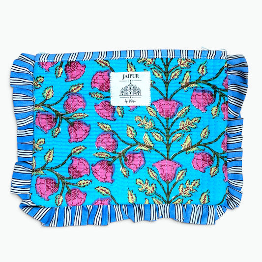 A square quilted fabric pouch or cover in bright turquoise blue, decorated with a pink rose and green vine pattern, finished with a blue and white striped ruffled border. A white brand label reading 'JAIPUR by Rani' is sewn onto the front.