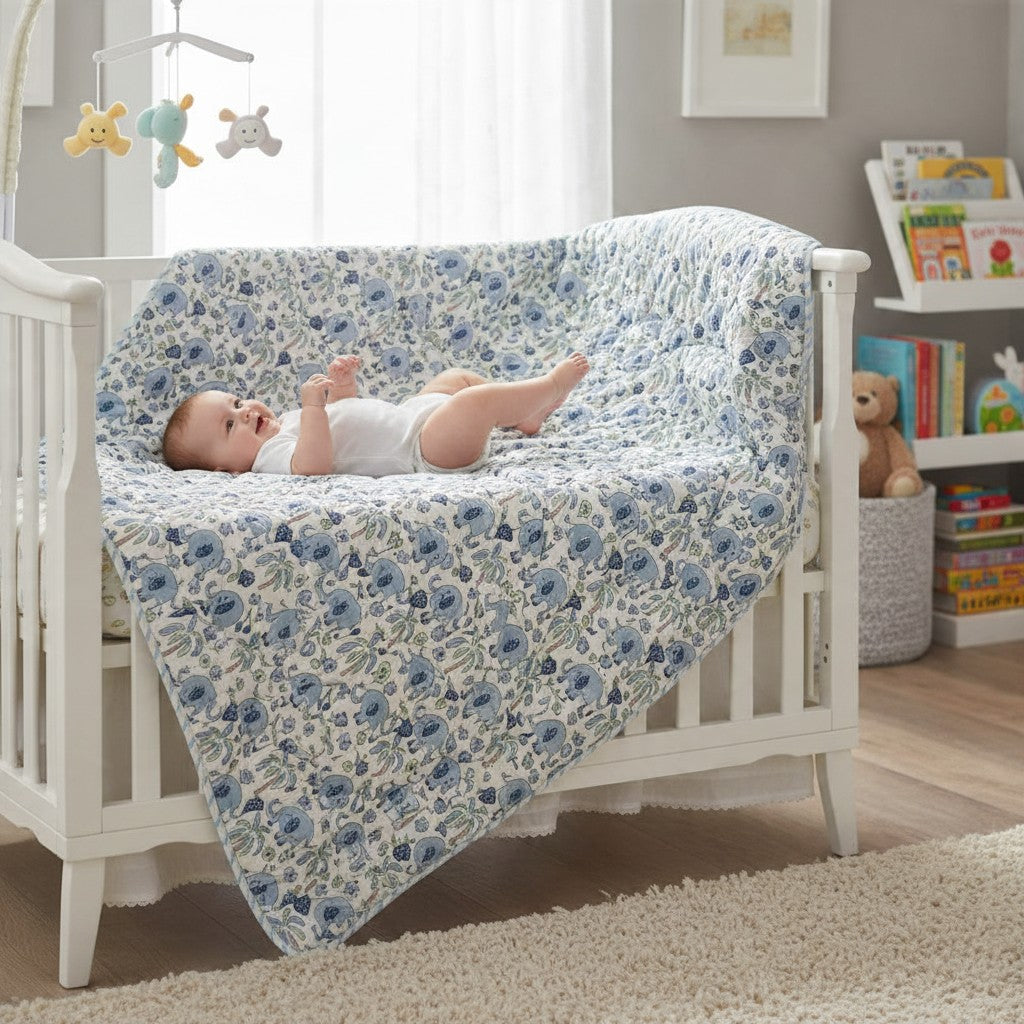 Blue and white cotton toddler quilt with little blue elephants and palm trees